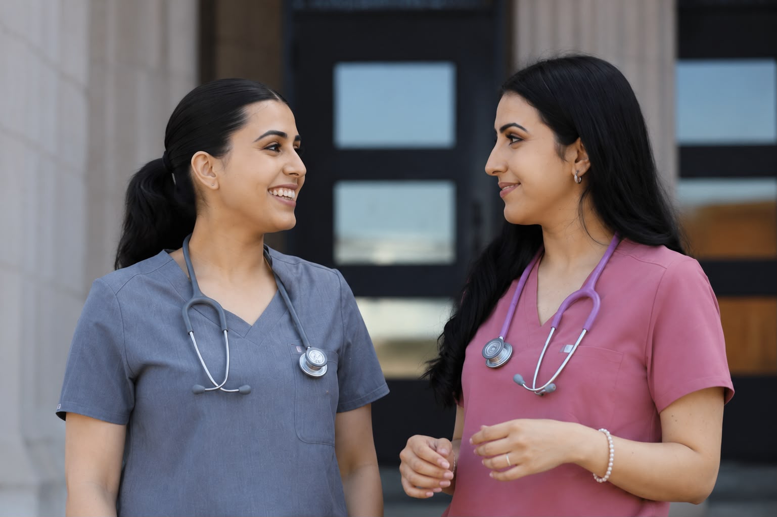 The two founding nurses of Lifeline Delegations in scrubs, talking together